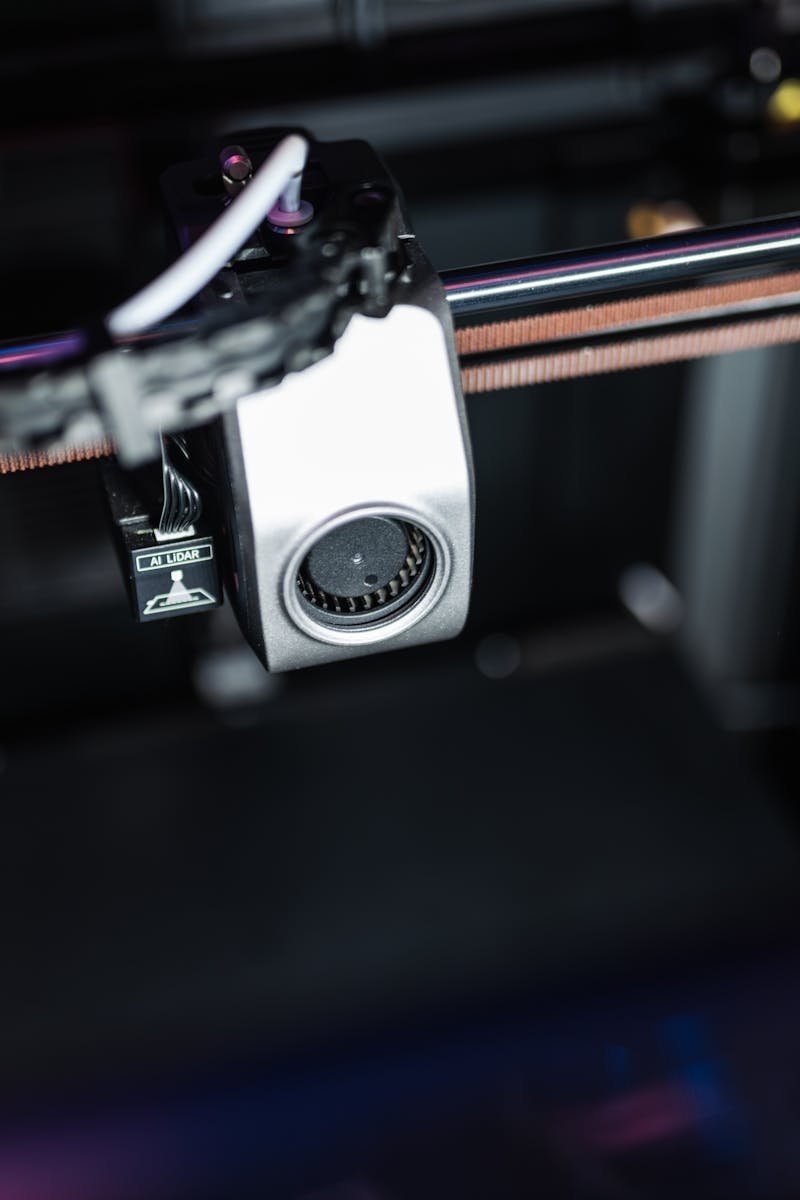 Detailed image showcasing the intricate components of a high-tech 3D printer in action.